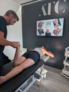 Physiotherapist providing treatment to a patient on a therapy table in Active Therapy Clinic, showcasing